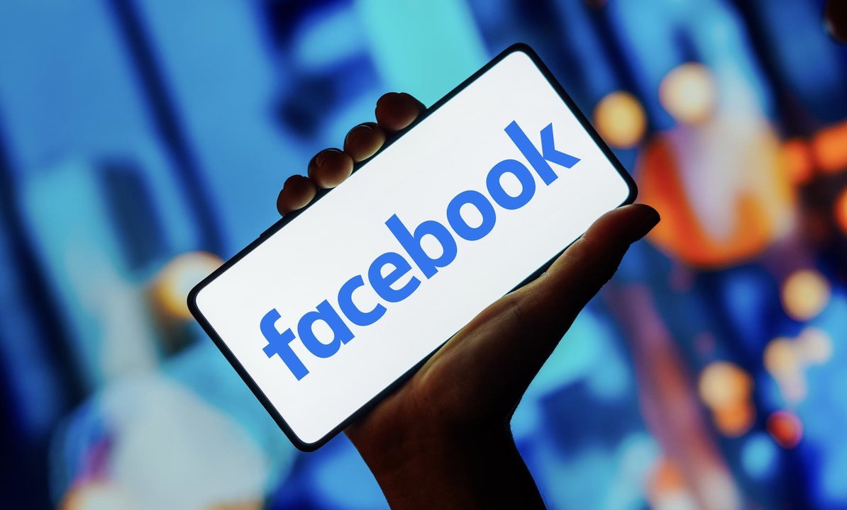 In this photo illustration, the Facebook logo is displayed on a smartphone screen.