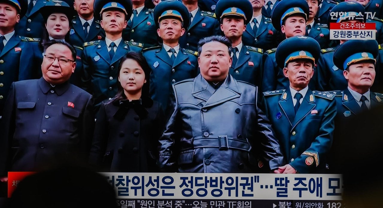 November 24, 2023, Seoul, South Korea: TV news at Seoul's Yongsan Railway Station shows North Korean leader Kim Jong Un (C) and his daughter (2nd from L, front row), believed to be named Kim Ju Ae, posing for a photo with scientists and engineers who contributed to the country's latest launch of a reconnaissance satellite, as he visited the National Aerospace Technology Administration in Pyongyang. North Korean leader Kim Jong-un has lauded the country's successful launch of a reconnaissance satellite as an eye-opening event of deploying a ''space guard'' monitoring enemies' military activities, state media reported on November 24. Kim made the remark during his visit to the National Aerospace Technology Administration (NATA) on November 23, as he encouraged engineers and scientists who contributed to November 22  launch of the  reconnaissance satellite Malligyong-1, according to the Korean Central News Agency,Image: 823987934, License: Rights-managed, Restrictions: , Model Release: no, Credit line: KIM Jae-Hwan / Zuma Press / ContactoPhoto