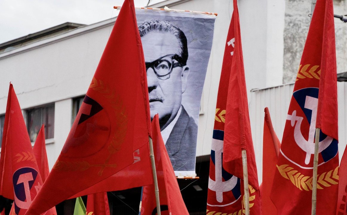 An image of Salvador Allende is seen amidst communist party flags during a march marking the 50th anniversary of the military coup led by Augusto Pinochet that overthrew President Allende, in Santiago, Chile.
