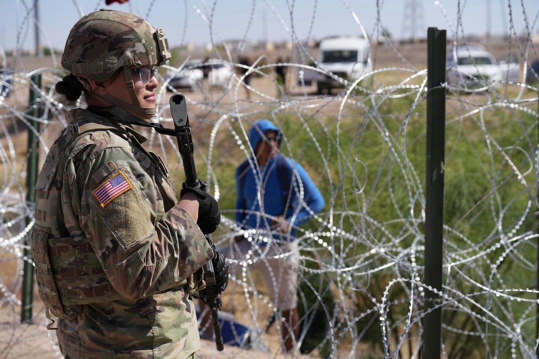 May 11, 2023, El Paso, TX, United States: People look across the border from Mexico at the Texas Army National Guard soldiers with the governors self-styled Texas Tactical Border Force, during Operation Lone Star Task Force West, May 11, 2023 near El Paso, Texas. The fear over a migrant surge after Title 42 expired failed to materialize with fewer migrants risking the tougher penalties under the new Title 8 rules.,Image: 775623428, License: Rights-managed, Restrictions: , Model Release: no, Credit line: Mark Otte/Texas National / Zuma Press / ContactoPhoto