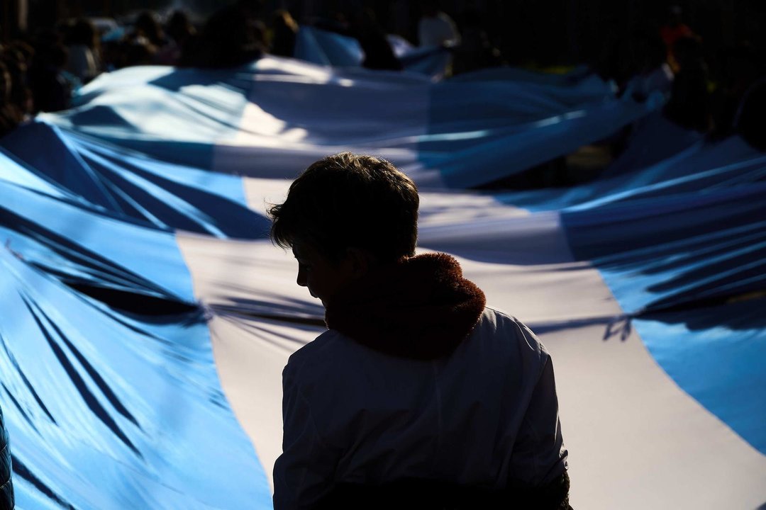 June 20, 2023, Firmat, Santa Fe, Argentina: A school boy is silhouetted against a giant national flag during the celebration of the National Flag Day commemorating the death of its creator, Manuel Belgrano, on June 20, 1820. During the Independence War, on Feb 27, 1812, by the Parana River opposite the place where the National Flag Memorial is located in Rosario, Santa Fe, Belgrano raised for the first time the National Flag. It was adopted as National Flag in 1816, after the Independence was declares, and a Sun of May inspired in the Incan God of the Sun was added in 1818.,Image: 784425567, License: Rights-managed, Restrictions: , Model Release: no, Credit line: Patricio Murphy / Zuma Press / ContactoPhoto
