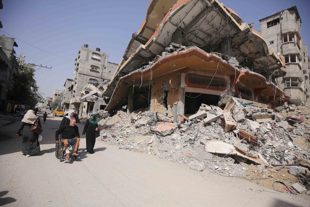 May 21, 2024, Bureij Camp, Gaza Strip, Palestinian Territory: Displaced Palestinians walk between buildings destroyed in Israeli bombardment in Bureij refugee camp in the southern Gaza Strip on May 21, 2024, amid the ongoing Israel war on Gaza,Image: 875074946, License: Rights-managed, Restrictions: , Model Release: no, Credit line: Omar Ashtawy / Zuma Press / ContactoPhoto