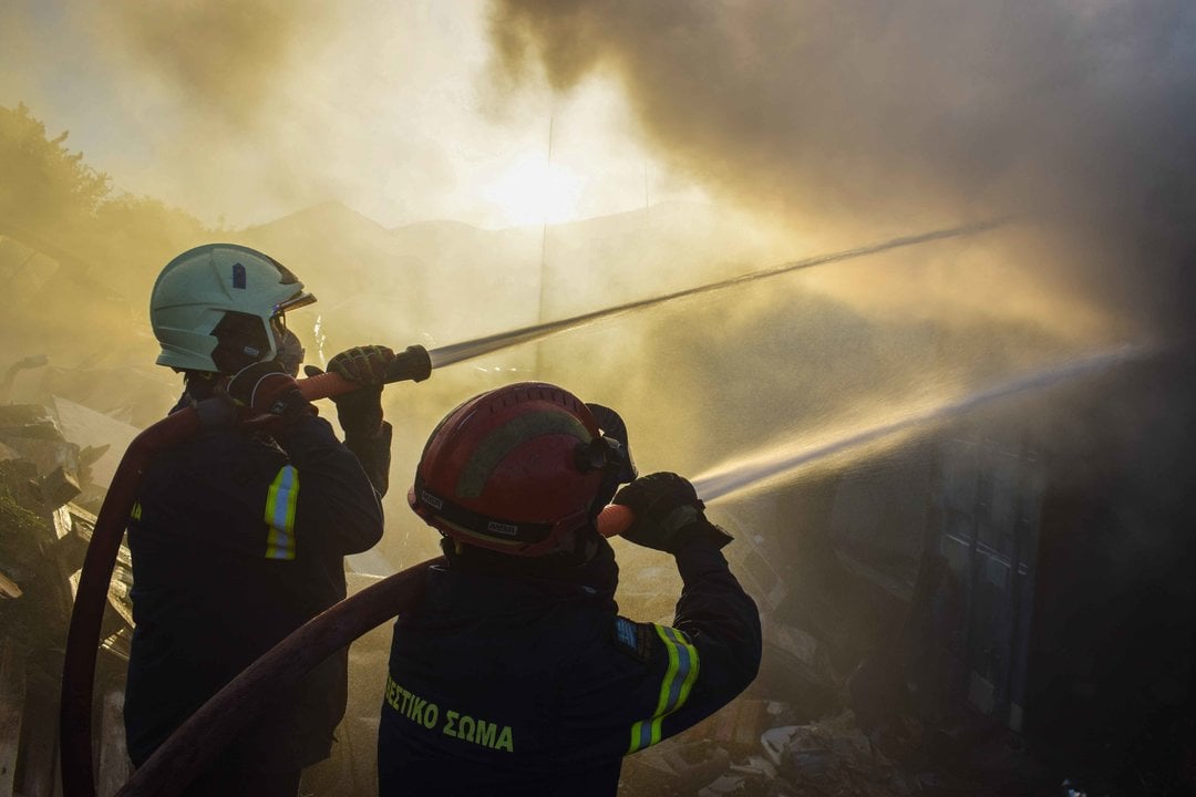 June 19, 2024, Koropi, Eastern Attica, Greece: Firefighters attempt to extinguish a fire amidst thick smoke that has broke out in a factory area during a wildfire in the eastern suburbs of the Greek capital. Authorities have urged residents to evacuate an area on the fringes of Athens where a large wildfire was spread by strong winds.,Image: 883730462, License: Rights-managed, Restrictions: , Model Release: no, Credit line: Dimitris Aspiotis / Zuma Press / ContactoPhoto