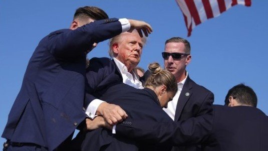 BEIJING, July 14, 2024  -- This video screenshot shows former U.S. President Donald Trump being helped off the stage at a rally in Butler, Pennsylvania of the United States after what sounded like gunshots rang out through the crowd, July 13, 2024.
  Video footage showed that Trump was making a speech when popping sounds rang out over the rally. Screams could be heard in the crowd, and Trump was swiftly escorted off the stage by Secret Service agents.
  Blood could be seen on the side of his head and his ear. He was quickly escorted into a vehicle, and his motorcade has left the venue.
  Trump is currently safe and is expected to survive, NBC News reported, quoting senior law enforcement officials.,Image: 889558859, License: Rights-managed, Restrictions: , Model Release: no, Credit line: Xin Hua / Xinhua News / ContactoPhoto