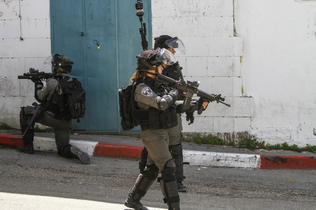 Israeli soldiers take their positions during a campaign to arrest Palestinians in the village of Shweika, near Tulkarm, in the northern West Bank. The Israeli authorities launched a massive arrest campaign among members of the Islamic resistance movement Hamas throughout the West Bank following the war between Israel and Gaza. Nasser Ishtayeh / Zuma Press / ContactoPhoto